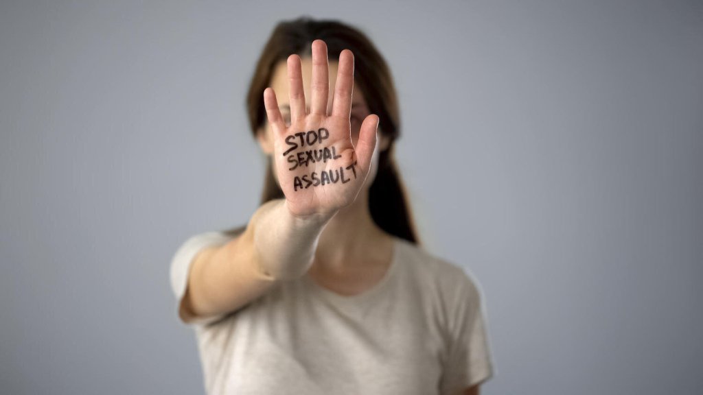 Stop sexual assault sign on womans hand, discrimination prevention, assault